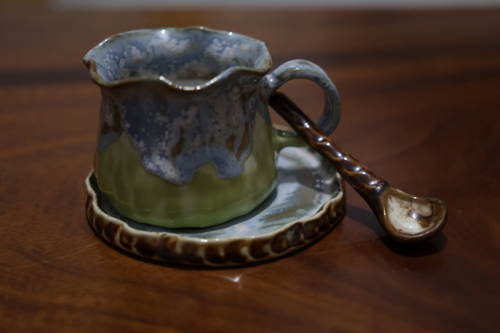 Artisanal pottery mug set with matching saucer and spoon in gift box