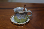 Artisanal pottery mug set with matching saucer and spoon in gift box
