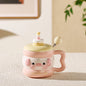 cute animal ceramic mug with lid on cozy desk setup