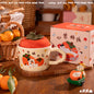 cute persimmon cat ceramic mug with lid on cozy coffee table
